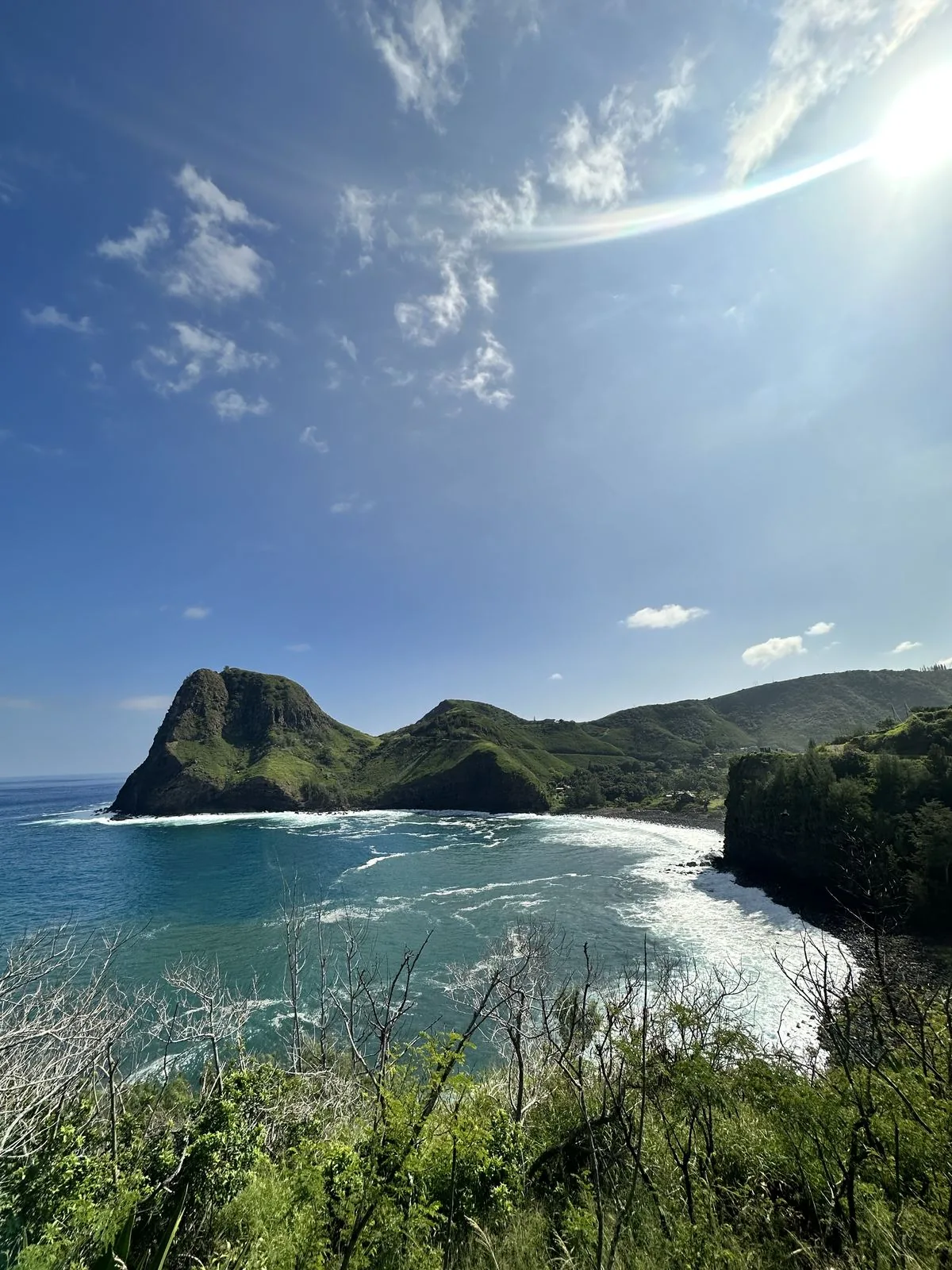 Sea cliffs and green ridges on the Maui coast, seen from a distance